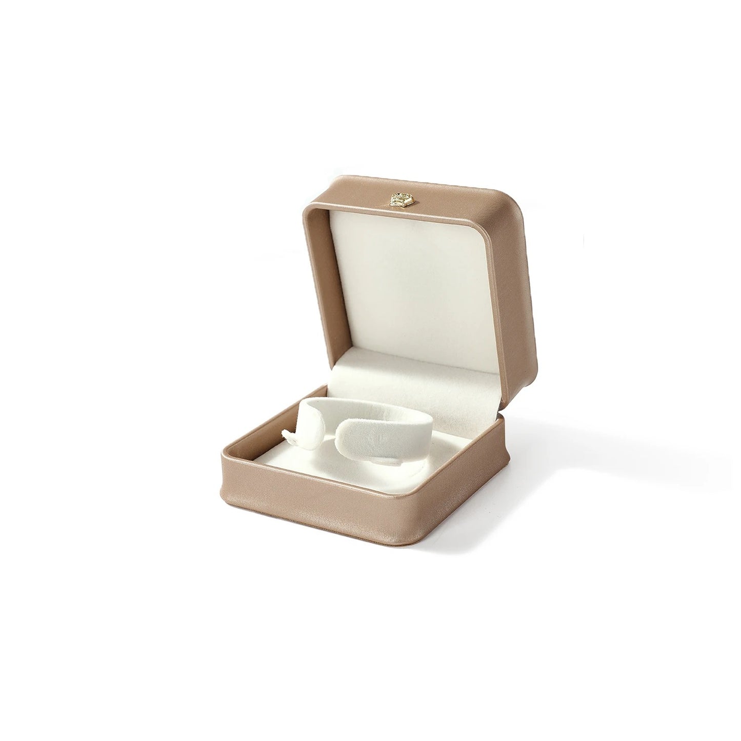 White ceramic teacup and saucer set in a beige jewelry box on a white background