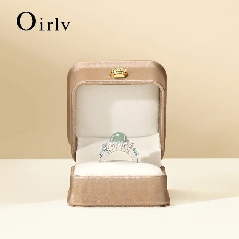 Ring in a beige box with 'Oirlv' branding on a beige background